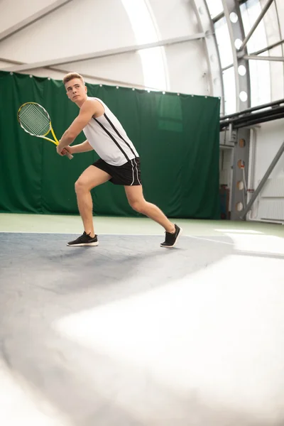 Young man play tennis outdoor on orange  court — Stock Photo, Image