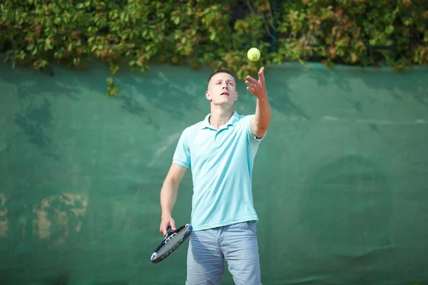Young man play tennis outdoor on orange  court — Stock Photo, Image