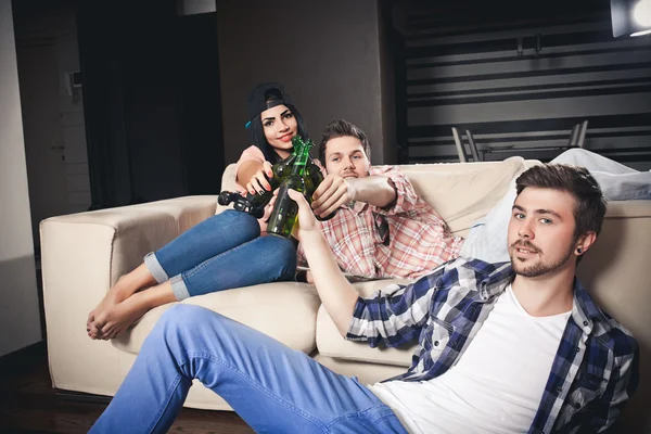 Playing video games while sitting on sofa — Stock Photo, Image