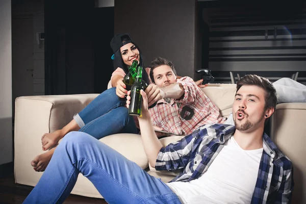 Playing video games while sitting on sofa — Stock Photo, Image