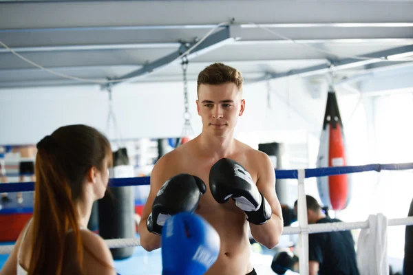 Hombre entrenador de boxeo entrena a mujer atleta para jugar y emparejar — Foto de Stock