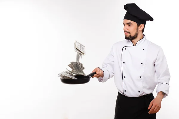 Gelukkig man in cook uniform aanhouden van geld op witte achtergrond — Stockfoto