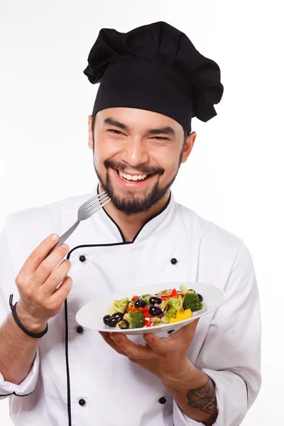 Koken mens blij met salade Stockfoto