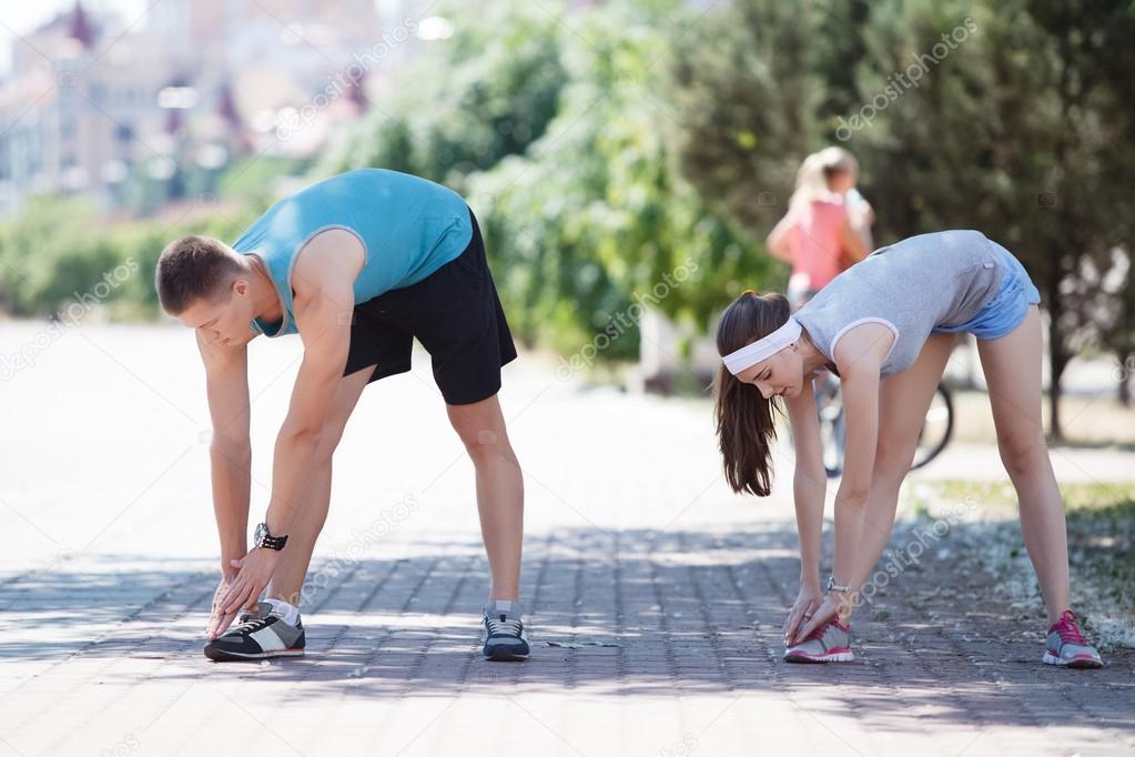 Happy couple training in the park