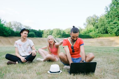 teknoloji ve insan kavramı - grup arkadaşları ile tablet pc bilgisayar, parkta oturan smartphone