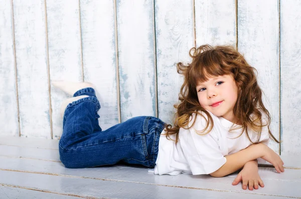 Little girl lying on floor — Stock Photo, Image