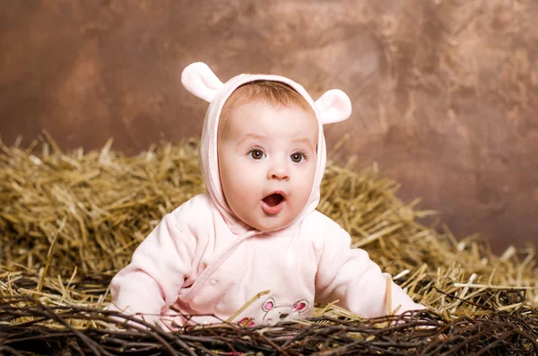 Little girl. child in pink overalls with ears. — Stock Photo, Image