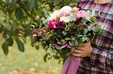 Gelin buketi. Güzel bir bouqu holding ekose bir elbise içinde gelin