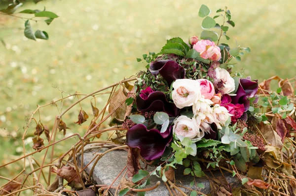 Beautiful wedding boho bouquet of red and pink flowers and green — Stock Photo, Image