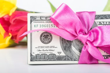 Şerit hediye üzerinde banknot yığını ile ilgili.