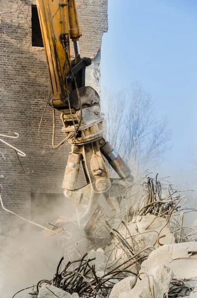 Excavator working at the demolition of an old industrial building. — Stock Photo, Image