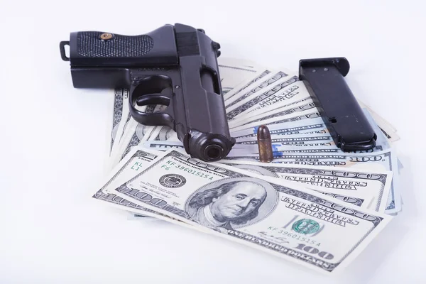 Gun with bullet on US dollar banknotes. — Stock Photo, Image