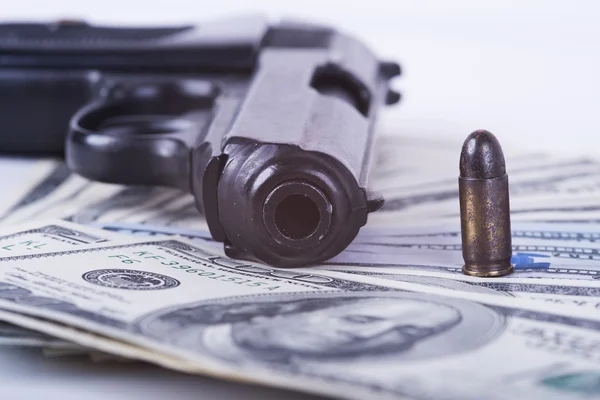 Gun with bullet on US dollar banknotes. — Stock Photo, Image