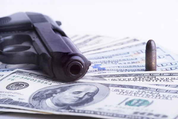 Gun with bullet on US dollar banknotes. — Stock Photo, Image