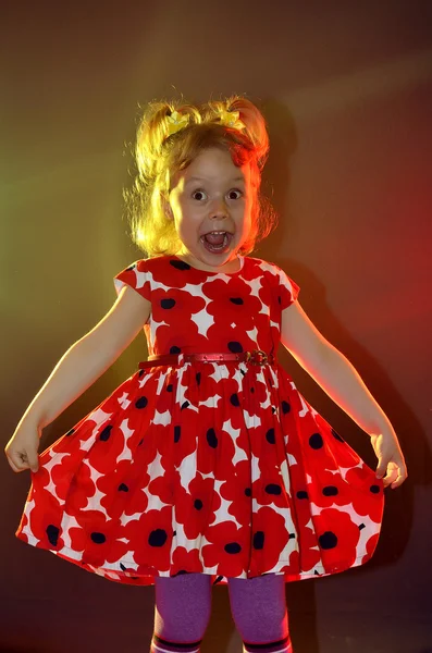 The artistic child on the stage in a beautiful dress. — Stock Photo, Image