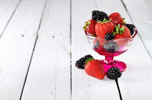 Berry Mix: strawberries and blackberries into a bowl on a wooden