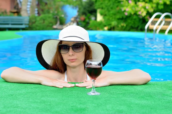 A woman relaxes in the pool.