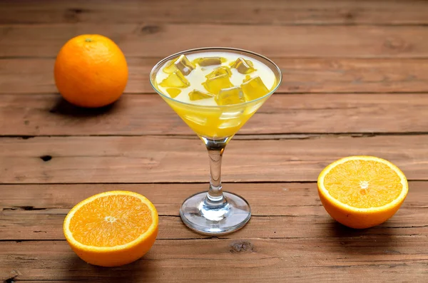 Fresh juice in a martini glass on a wooden table. — Stock Photo, Image