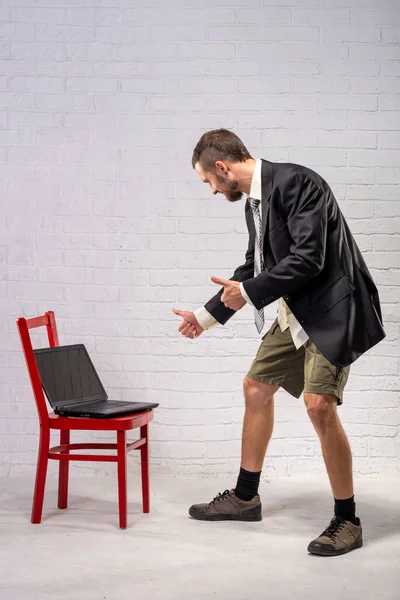 Business Man Business Suit Shorts Looks Laptop Shows Sign Remote — Stock Photo, Image