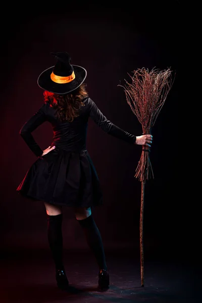 Young Woman Black Dress Witch Hat Broomstick Her Hand Posing — Stock Photo, Image