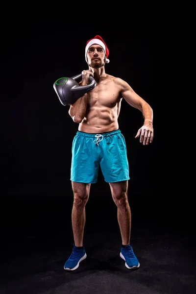 Athletic Man Santa Hat Trains Kettlebell Black Background Fitness Kettlebell — Stock Photo, Image