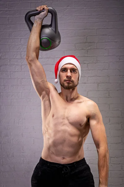 Sporty Man Santa Hat Kettlebell His Hand Close Fitness Kettlebell — Stock Photo, Image