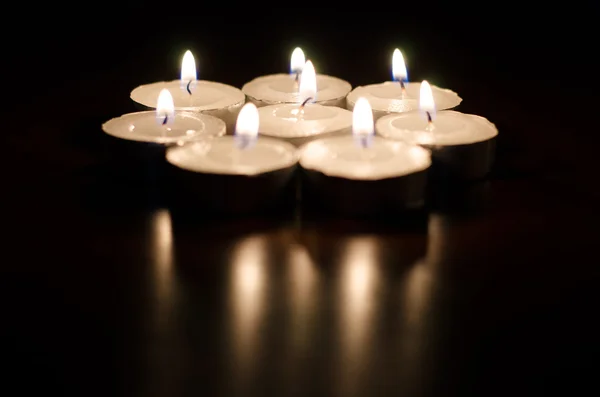 Group of burning candles on black background — Stock Photo, Image