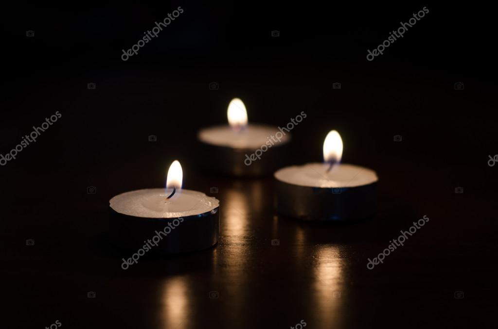 Dos velas negras ardiendo por la Foto de stock 1688704228
