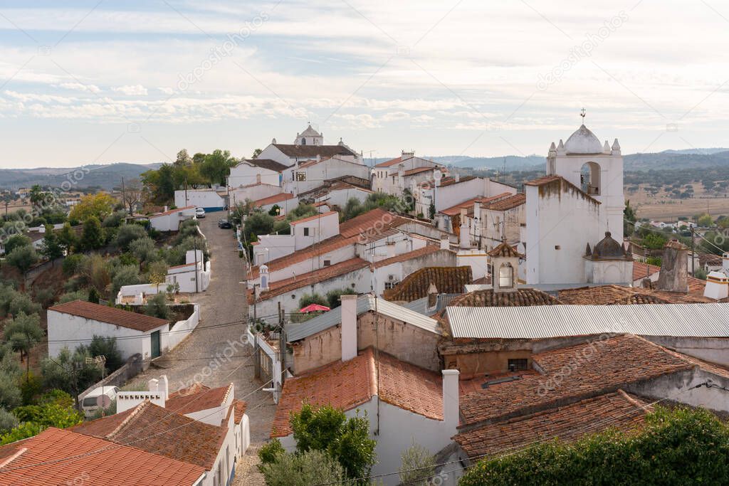 Terena village white traditional houses and church seen from the castle, in Portugal