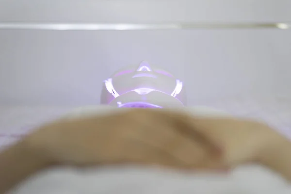Woman With Led Light Therapy Facial Beauty Mask Photon Therapy. Woman receiving face light therapy in LED mask.