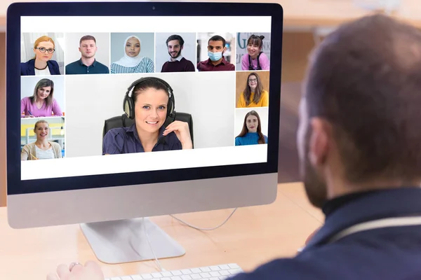 Online remote school class concept. Mixed race college student distance learning using computer conferencing with teacher and classmates group.Teaching and learning from home during quarantine and coronavirus outbreak.