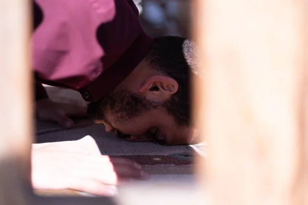 African Muslim Man Making Traditional Prayer To God. Religious black muslim man praying inside the mosque during ramadan