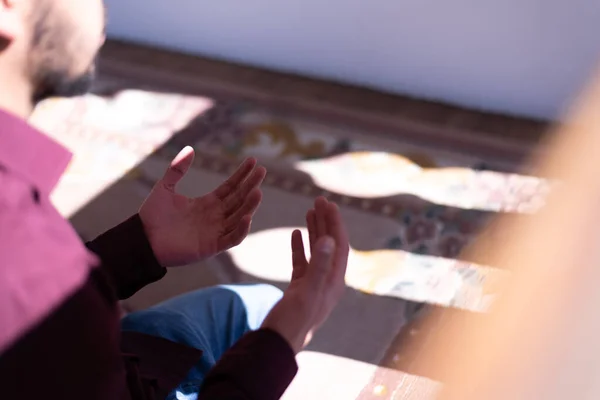 African Muslim Man Making Traditional Prayer To God. Religious black muslim man praying inside the mosque during ramadan