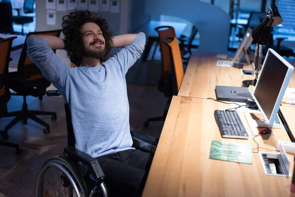 Disabled businessman working in modern office. Disability, technology and succes concept