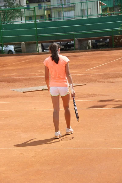 Belle jeune fille sur le court de tennis — Photo