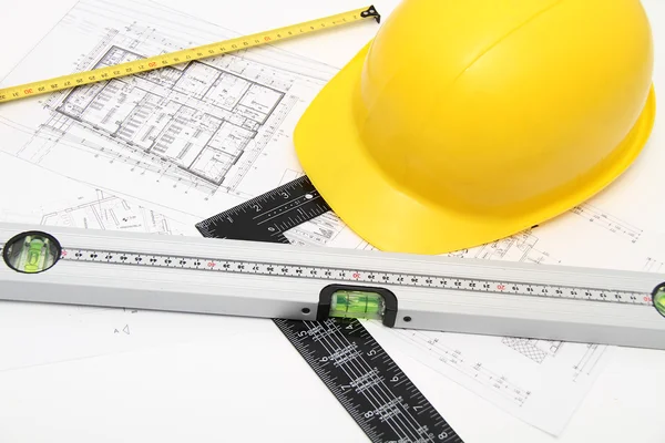 Helmet and tools for construction drawings and buildings — Stock Photo, Image