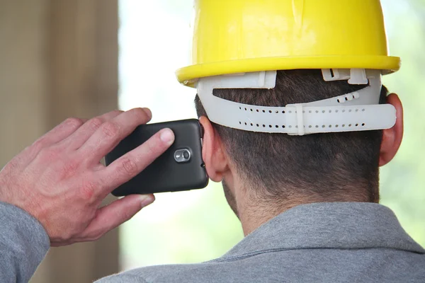 Engineer at a construction site making a business call — Stock Photo, Image