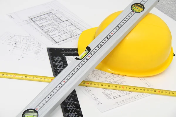 Helmet and tools for construction drawings and buildings — Stock Photo, Image