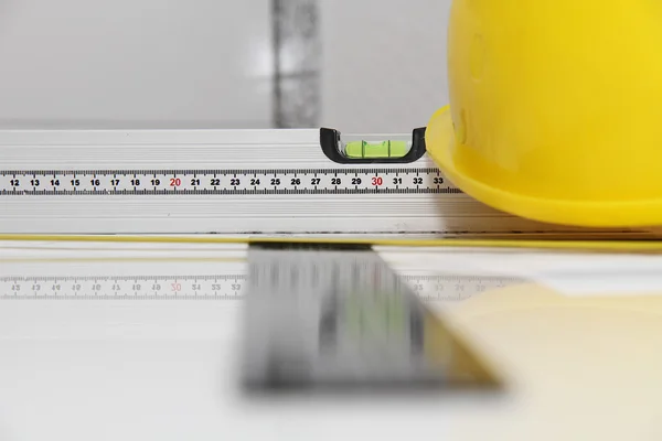 Helmet and tools for construction drawings and buildings — Stock Photo, Image