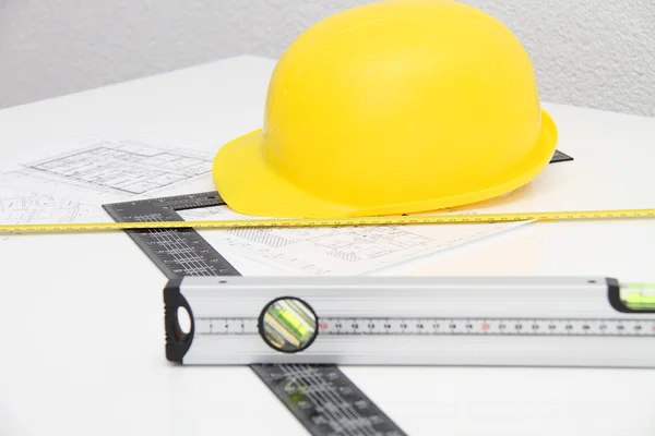 Helmet and tools for construction drawings and buildings — Stock Photo, Image