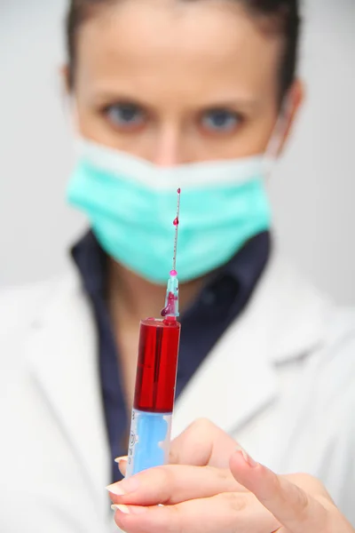 Syringe of Red Blood Test for research HIV AIDS Concept Idea — Stock Photo, Image