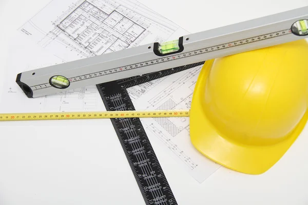 Helmet and tools for construction drawings and buildings — Stock Photo, Image