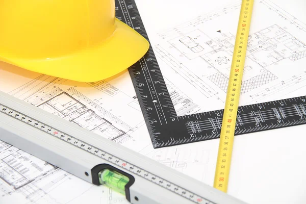 Helmet and tools for construction drawings and buildings — Stock Photo, Image