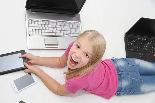 Little child playing at home with tablet, laptop and phone — Stock Photo, Image