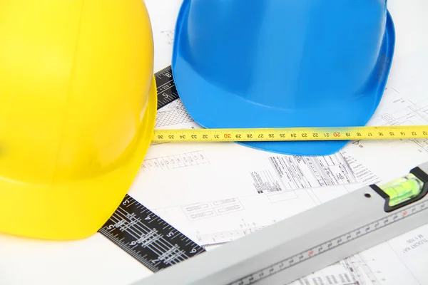 Helmets and tools for construction drawings and buildings — Stock Photo, Image