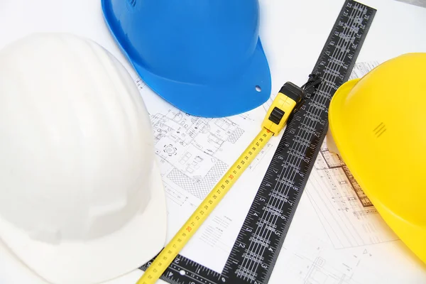 Helmets and tools for construction drawings and buildings — Stock Photo, Image