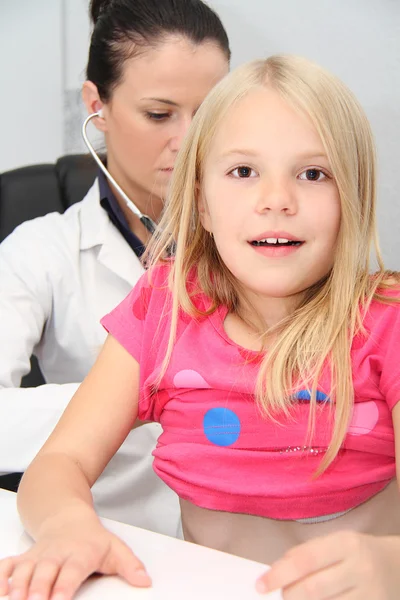 Young female child examined by woman doctor — Stock Photo, Image