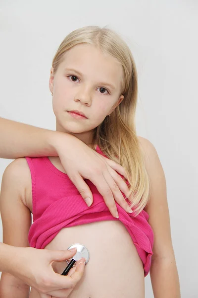 Little girl being listened by a doctor — Stock Photo, Image