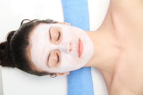 Beautiful young blue eye woman with clay facial mask — Stock Photo, Image