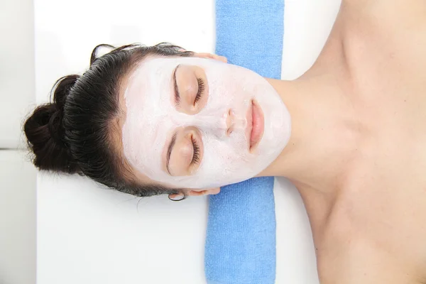 Beautiful young blue eye woman with clay facial mask — Stock Photo, Image